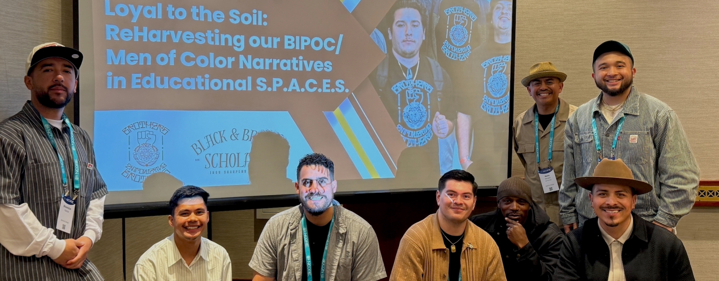 photo of seven Men of Color in front of a presentation screen
