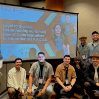 photo of seven Men of Color in front of a presentation screen