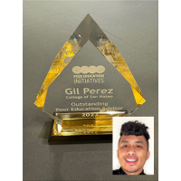 triangular glass award with headshot of Gil Perez in lower right corner
