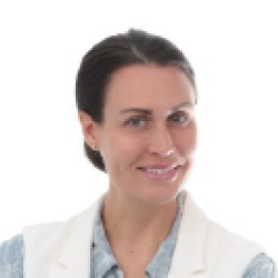 photo of Carrie Mitran smiling, dark hair pulled back, white skin, blue eyes white vest with blue blouse